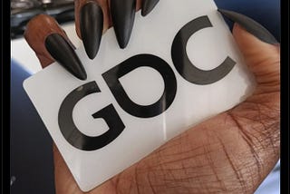 tweet from Jay Justice wheelchair emoji @GDC recovery  @thatjayjustice  We in here y’all party emoji embedded image is the hand of a dark-skinned Black woman with long black stiletto nails holding a white plastic card that says GDC on it in black text #GDC  8:25 PM · Mar 20, 2022·Twitter for Android