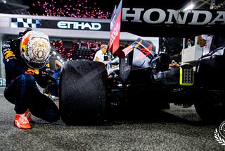 Max Verstappen takes a knee after winning the championship race in Abu Dhabi