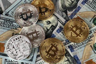 Physical Bitcoin Coins on US Dollar Bills
