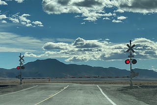 The view toward the south of a railroad crossing where NM 47 intersects with US 60 south of Belen, New Mexico