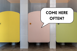 A bathroom stall with a speech bubble that says “come here often?”
