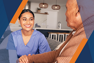 A caregiver smiles at an older adult