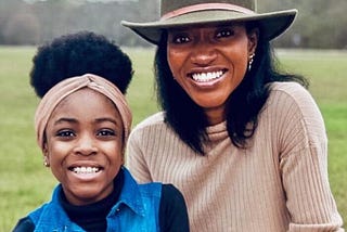 Picture of Toyosi Babalola and her daughter at a park.