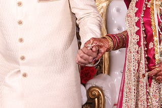 Newly wed couple in India holding hands. Photo by Saad on Unsplash.com