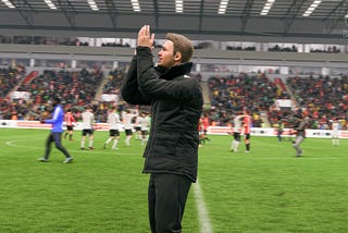 Sheffield Wednesday manager Josh Brewer applauds club supporters after a Premier League match.