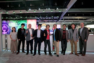 A group of Nintendo employees, executives, and legendary game developers gather for a photo above their June 2019 E3 showroom in the Los Angeles Convention Center.