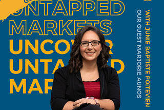 Marjorie is sitting in a wheelchair, smiling wearing a black cardigan, black pants and a red shirt. Behind Marjorie, there is a navy blue background with the podcast title juxtaposed one on top of the other. It says Uncover Untapped Markets in bold yellow at the top and regular yellow font at the bottom. On the right-hand side it says: with Junie Baptiste Poitevien, who is the podcast host. Underneath it, it says: our podcast guest Marjorie Aunos.
