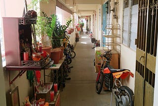 A slightly — yet pleasantly — cluttered hallway from a housing development in Singapore.
