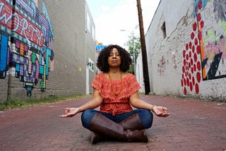 Tara meditating in a Washington D.C. alley.
