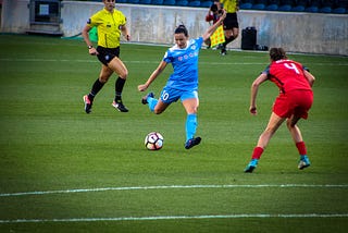 women playing football