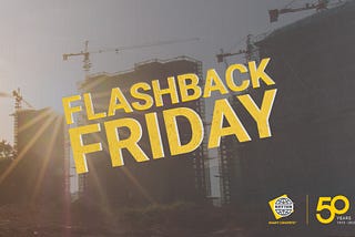A bright view of construction with cranes near some structures can be seen in the background while the yellow-and-white phrase “Flashback Friday” rests overtop in the foreground. Near that phrase, there are two logos on the bottom-right corner, one for Kryton and the other marking Kryton’s 50-year anniversary.