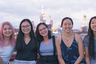 Photo of 5 Asian American women in front of the NYC skyline