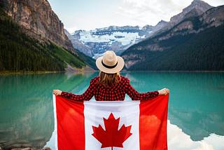 A person holding Canada’s flag