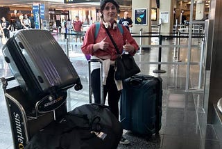 My 18 year old daughter at the airport with all of her suitcases checking them to fly to college.