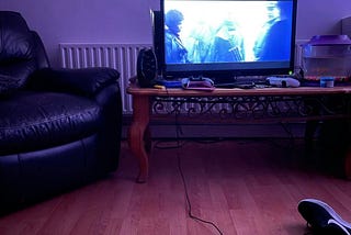 A television showing a film late at night in a low light