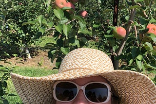 The author standing in front of her favorite apple tree.