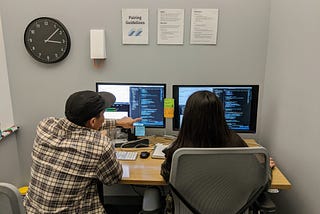 Two of our engineers talking through some code during a pairing session