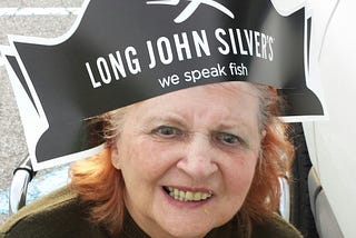 Woman wearing a Long John Silver’s hat.