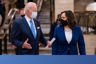 Screenshot from joebiden.com with Joe and Kamala walking together wearing PPE.