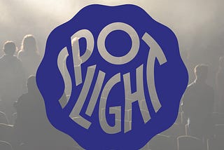 The Logo for Spotlight. A Theatre audience is backlit as they stand facing the stage.