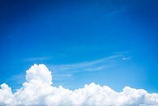 Blue sky with some white billowy clouds