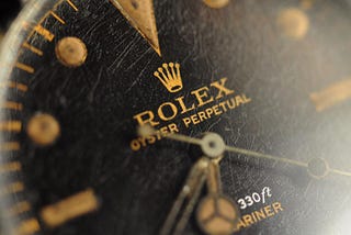 Old Rolex dial macro with gilt logo and spider (cracked) texture