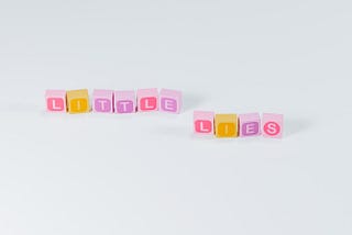 Colorful blocks of letters arranged to spell out the phrase little lies.