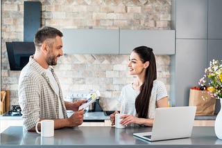A male and a female having a conversation over a hot drink.