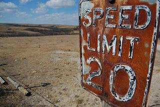 A rusted speed limit sign in the middle of nowhere