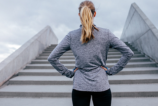 Woman staring up at steps ahead of her