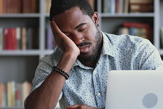 man asleep at laptop