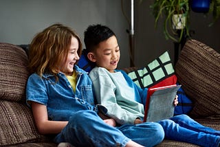 Two children doing home school work together