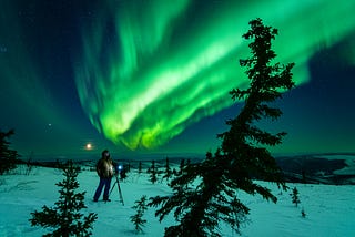 My new friend Jeff stares up at the sky, taking in the awe and wonder of a moment we had worked so hard to catch. The northern lights oscillated green and yellow in waves above our heads.