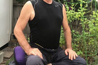 The author, happily meditating in the garden, on his meditation bench.