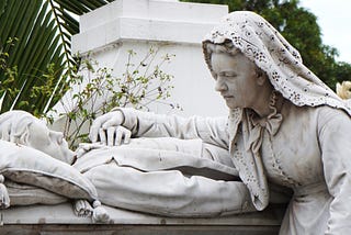 A statue of a grieving wife on the bedside of her dying husband. Death and Grief.