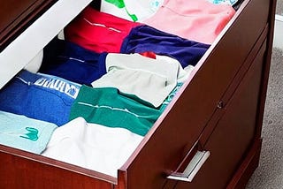 AI generated image of folding clothes in a dresser drawer