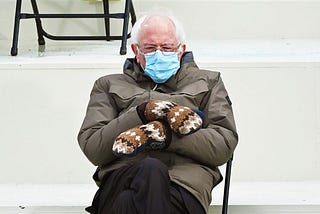 Bernie Sanders wearing brown and white mittens.