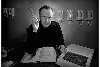 Photograph of Marshall McLuhan reading a book.