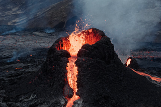 A volcano spewing lava representing the poems eruption