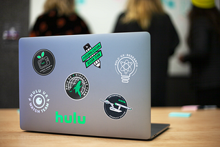 A laptop with the design team stickers