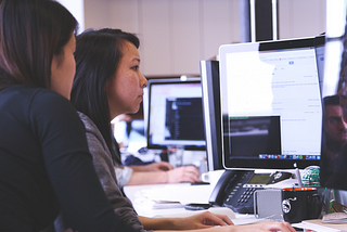 Two people working on computers.