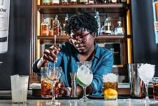 A bartender mixing drinks.