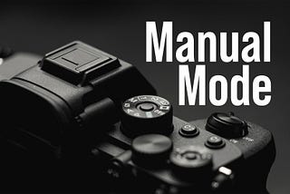 A closeup of a camera set to manual mode.