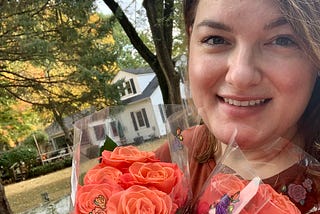 The author walking on a beautiful autumn day while appreciating the beauty of coral roses.