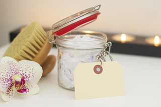 Self-care items, a brush and a flower sitting on a table