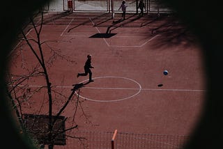 A person on a court racing towards a ball