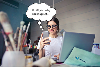 An introvert woman texting on her phone- answering why to the question “why are you so quiet?”