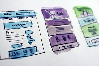 Hand-drawn wireframes watercolored in blue, purple, and green