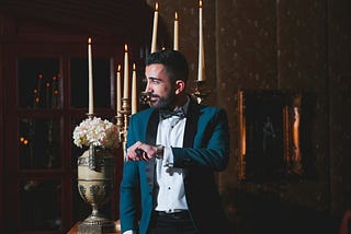 A man in blue jacket checking his watch