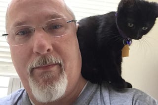 The author with his daughter’s cat pretending to be a parrot.